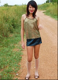Unabashed ladyboy Gold posing all naked alfresco